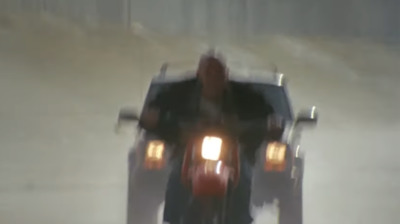 a man riding a motorcycle in the rain