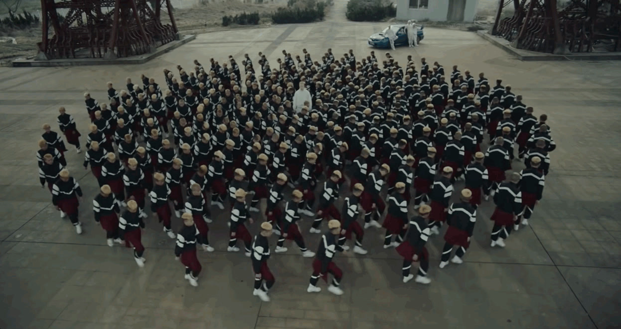 a large group of people dressed in black and red