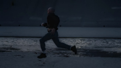 a man is running in the street at night