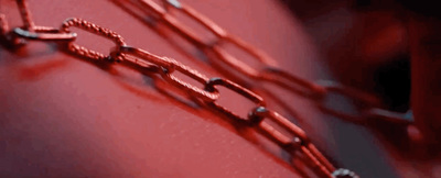 a close up of a chain on a red surface