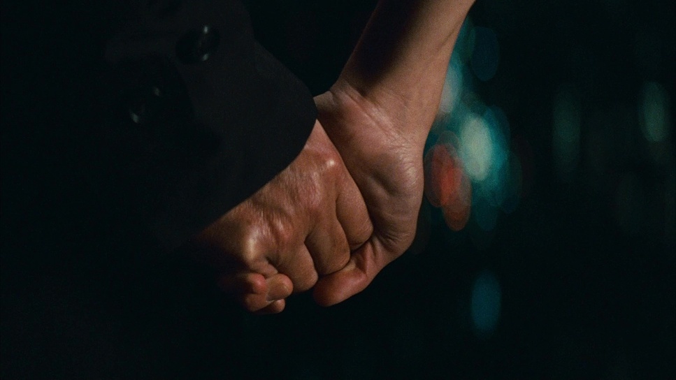 a close up of a person holding the hand of another person