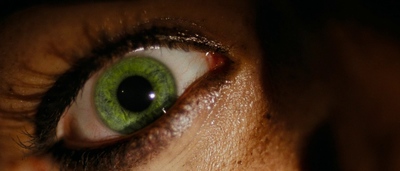 a close up of a person's green eye