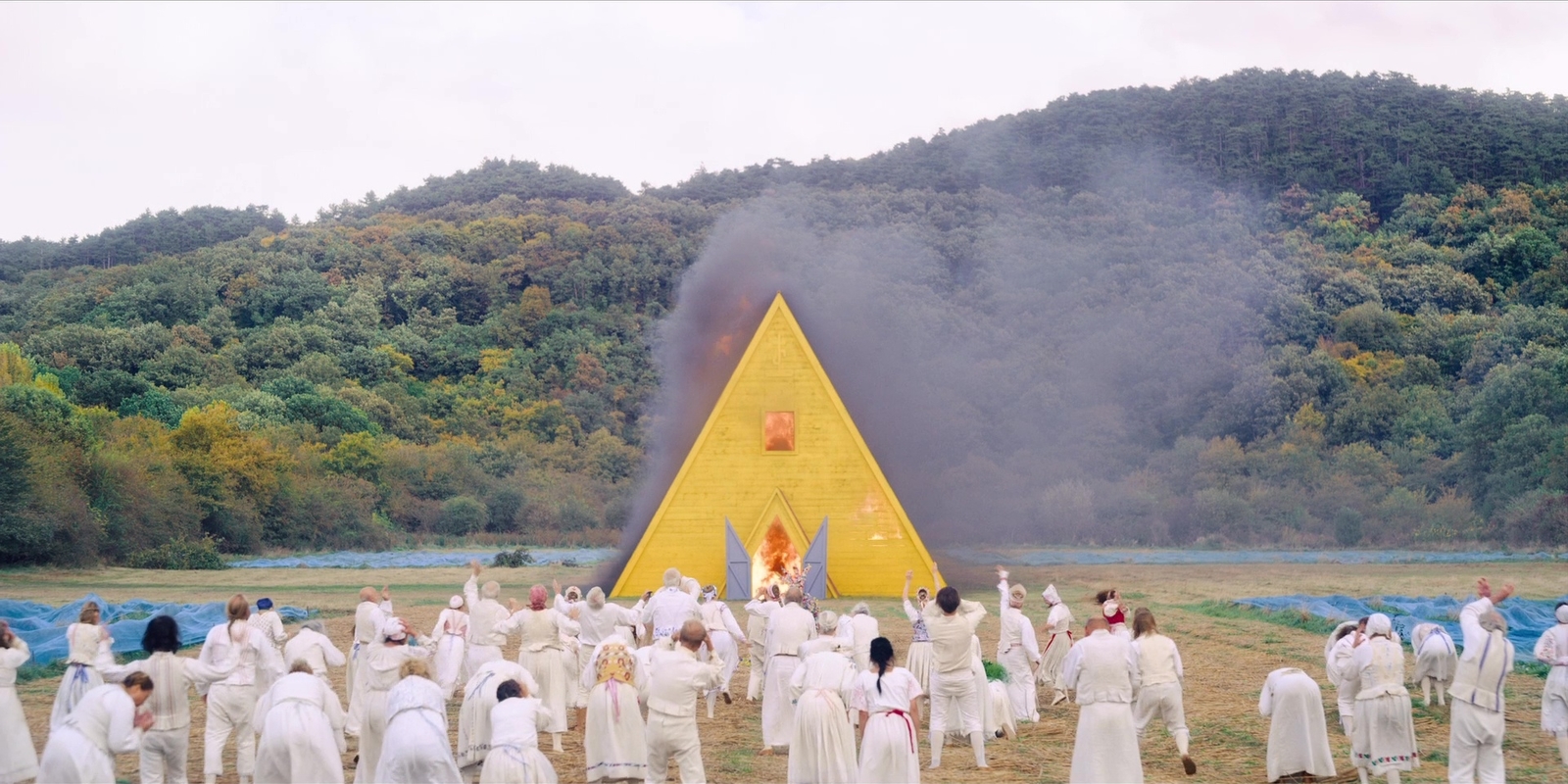 a large group of people standing in front of a pyramid