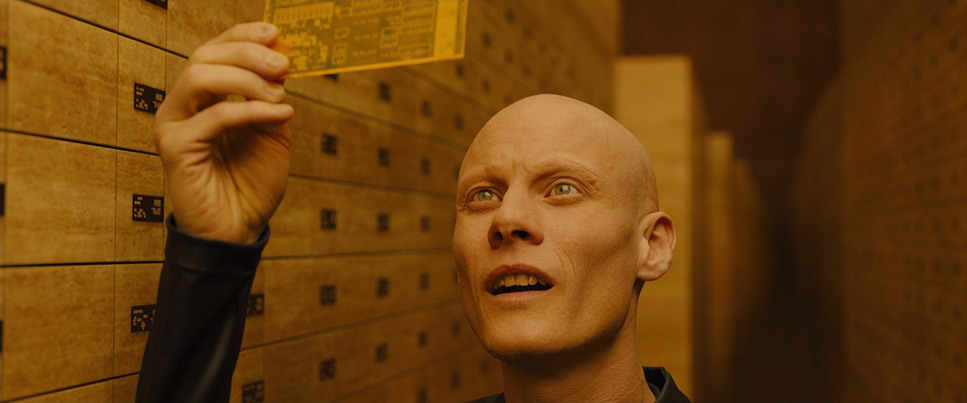 a man with a bald head is holding a file cabinet