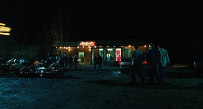 a group of people standing outside of a building at night