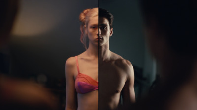 a man and a woman standing in front of a mirror