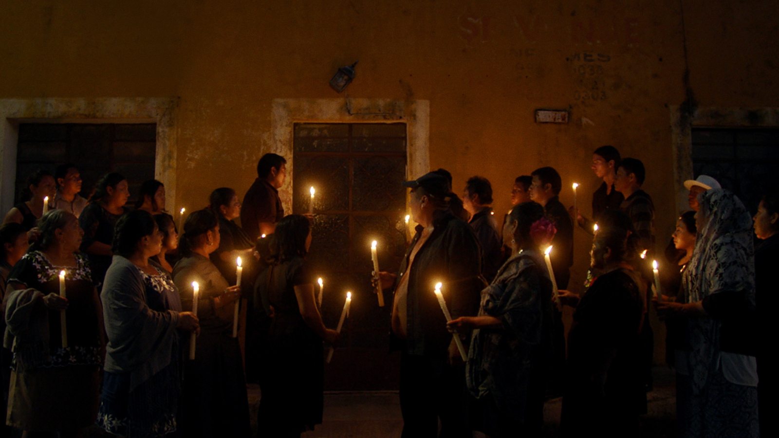 a group of people holding candles in their hands