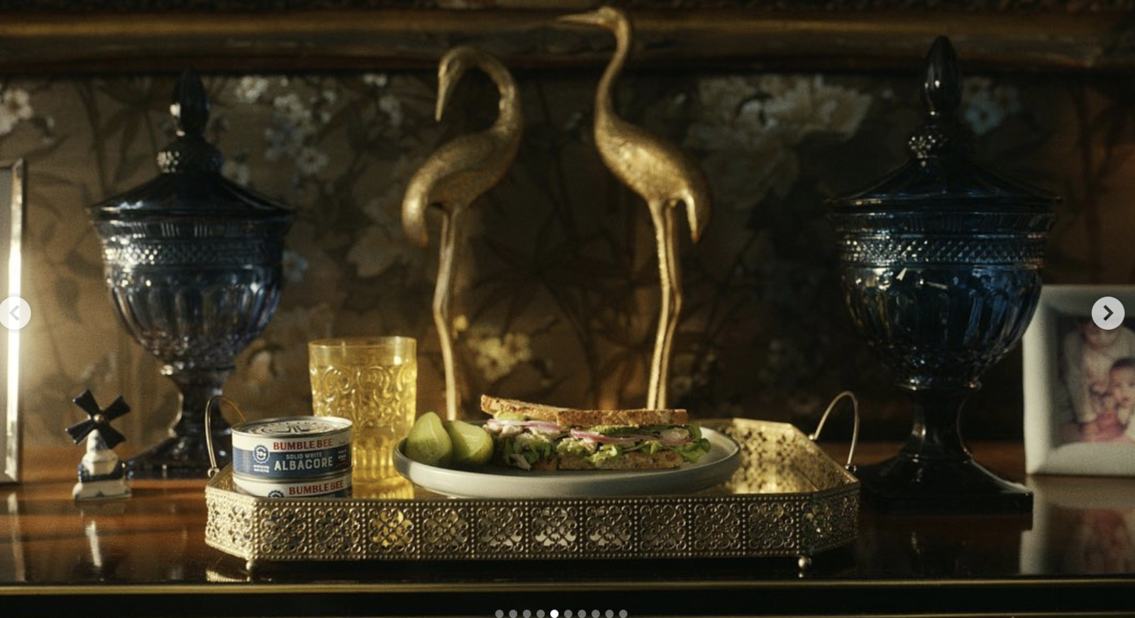 a table topped with a plate of food and two vases