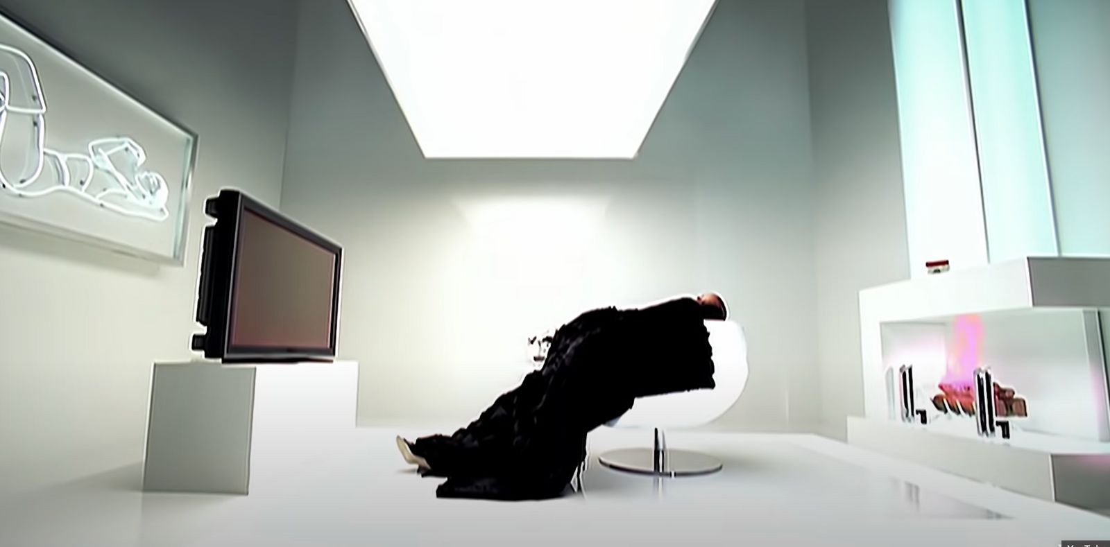 a white room with a television and a sculpture