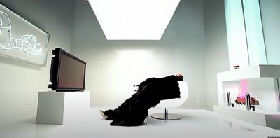 a white room with a television and a sculpture