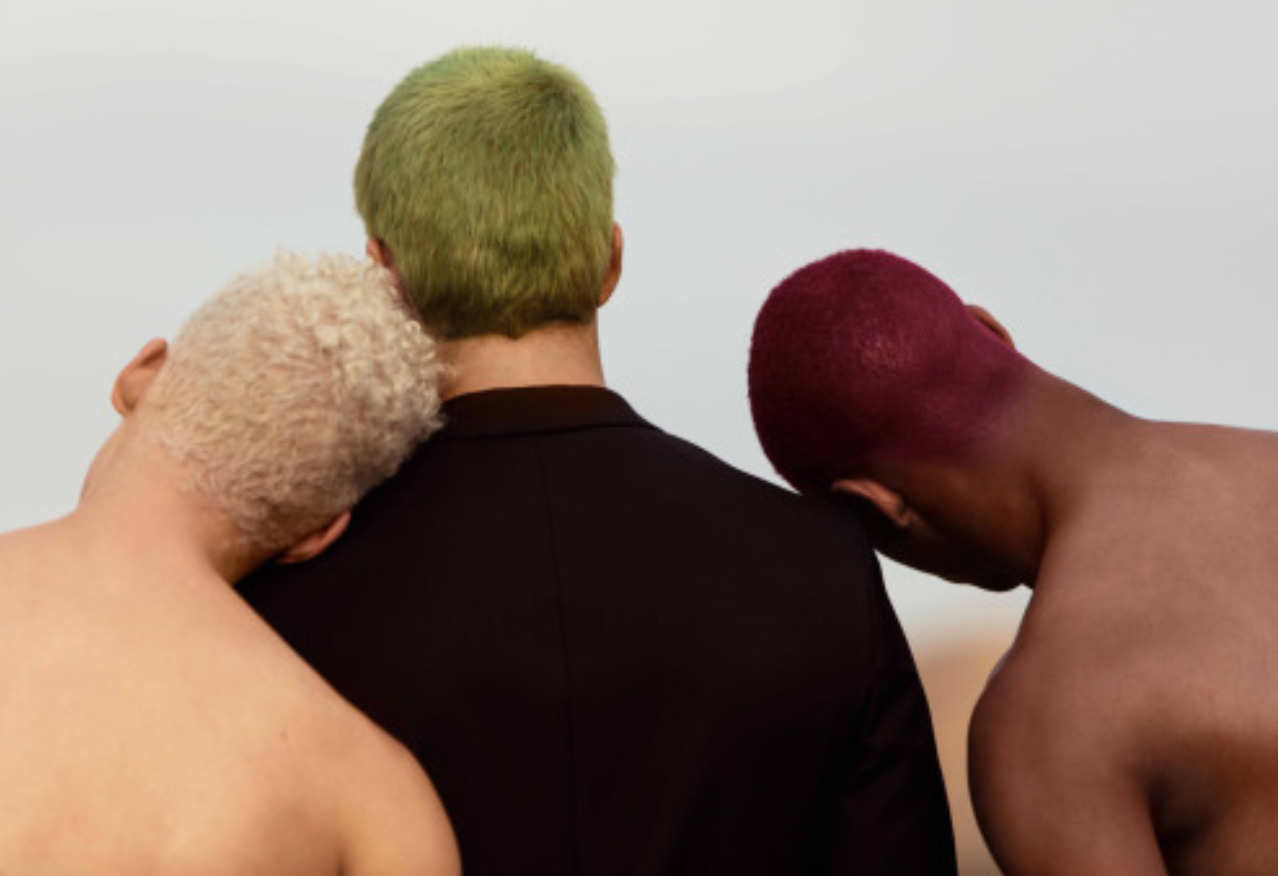 two men with different colored hair standing next to each other