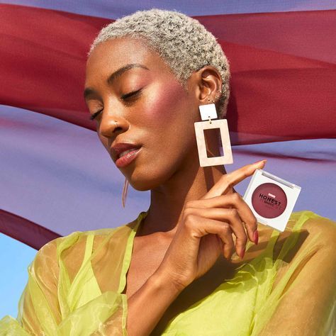 a woman holding a compact compact compact compact compact compact compact compact compact compact compact compact