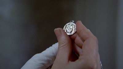 a close up of a person holding a ring