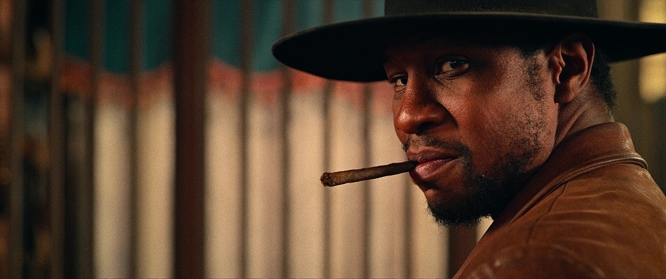 a man with a hat and a cigar in his mouth