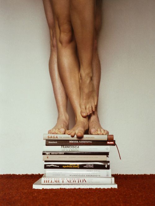 a person standing on top of a stack of books