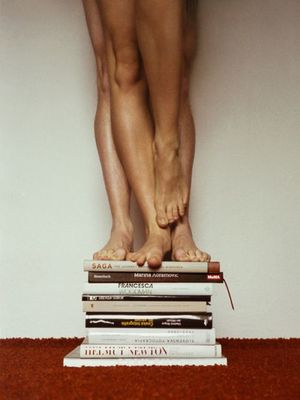 a person standing on top of a stack of books