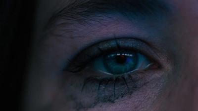 a close up of a person's blue eye