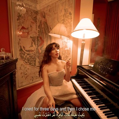 a woman in a white dress sitting at a piano