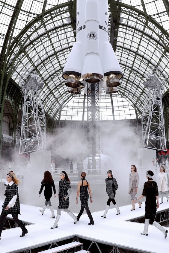 a group of people walking down a runway