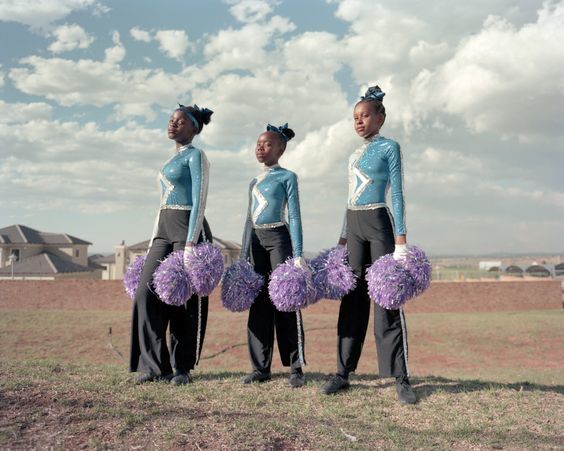 a group of young women standing next to each other