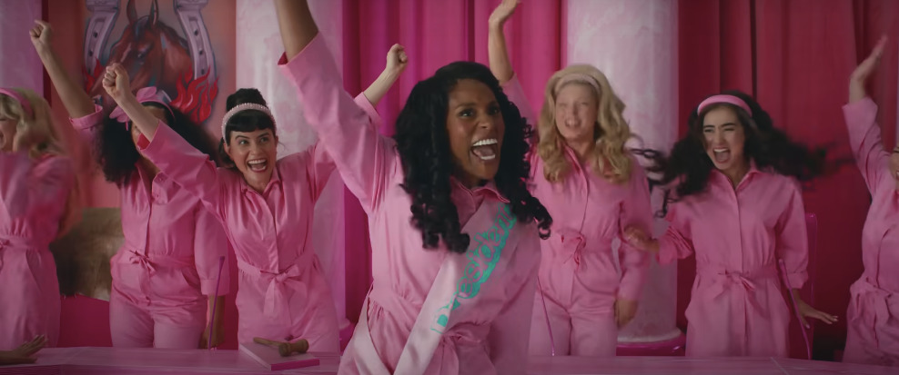 a group of women in pink pajamas posing for a picture