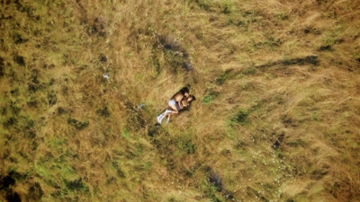 a couple of people laying in the grass