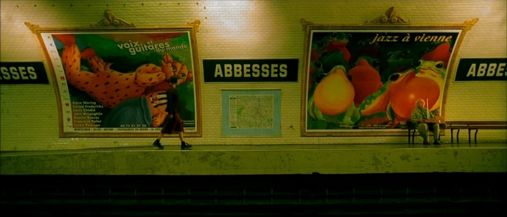 a subway station with posters on the wall