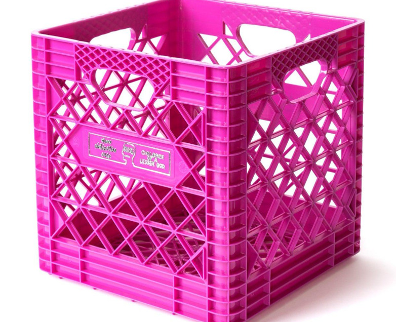 a pink plastic crate sitting on top of a white surface