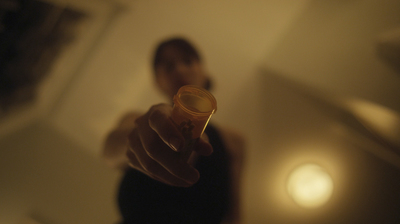 a blurry photo of a person holding a glass