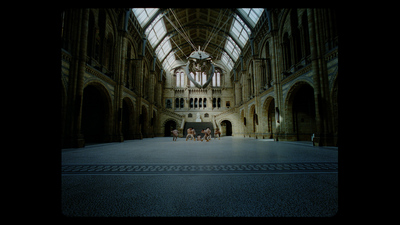 a group of people sitting on a bench in a large building