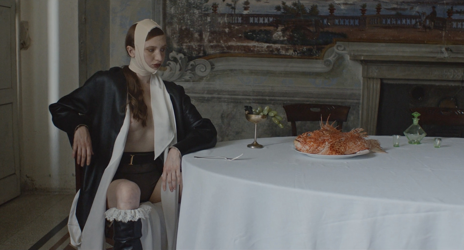 a woman sitting at a table with a plate of food