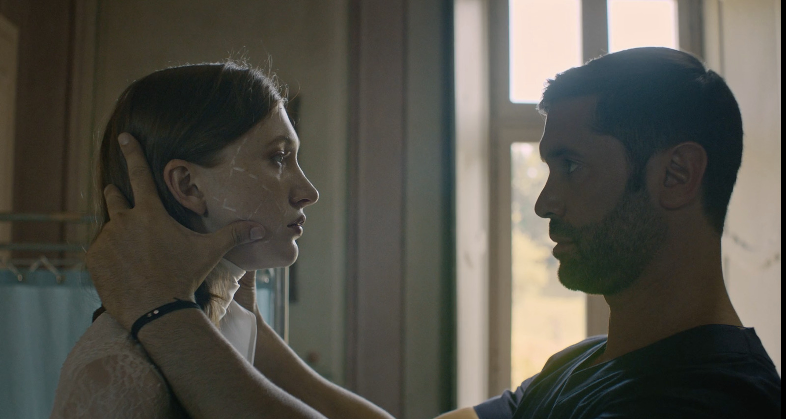 a man shaving a woman's face in a bathroom