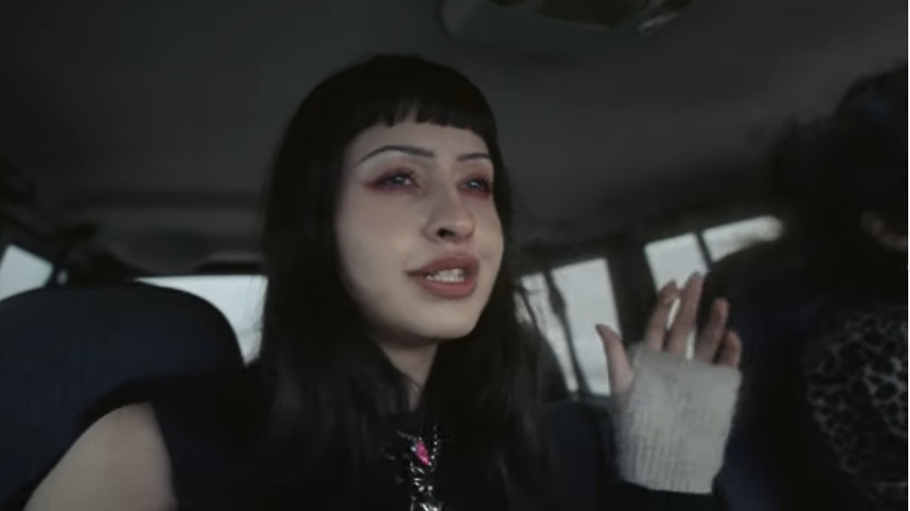 two women sitting in the back seat of a car