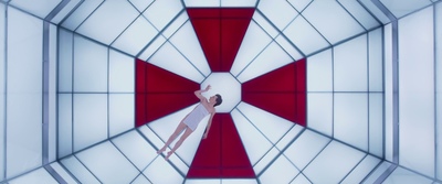 a woman in a white dress is standing in a red and white room