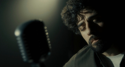 a man holding a microphone in a dark room