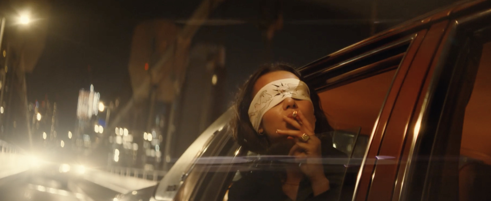 a woman with bandages on her head smoking a cigarette