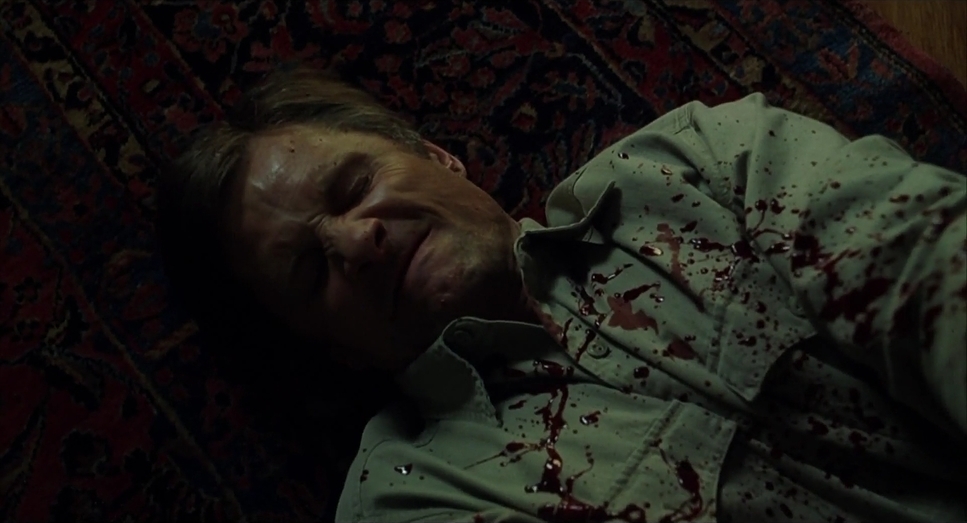 a man laying on the floor covered in blood