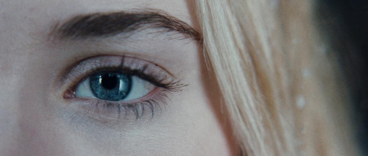 a close up of a woman's blue eyes