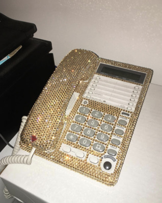 a cell phone covered in gold and silver sequins