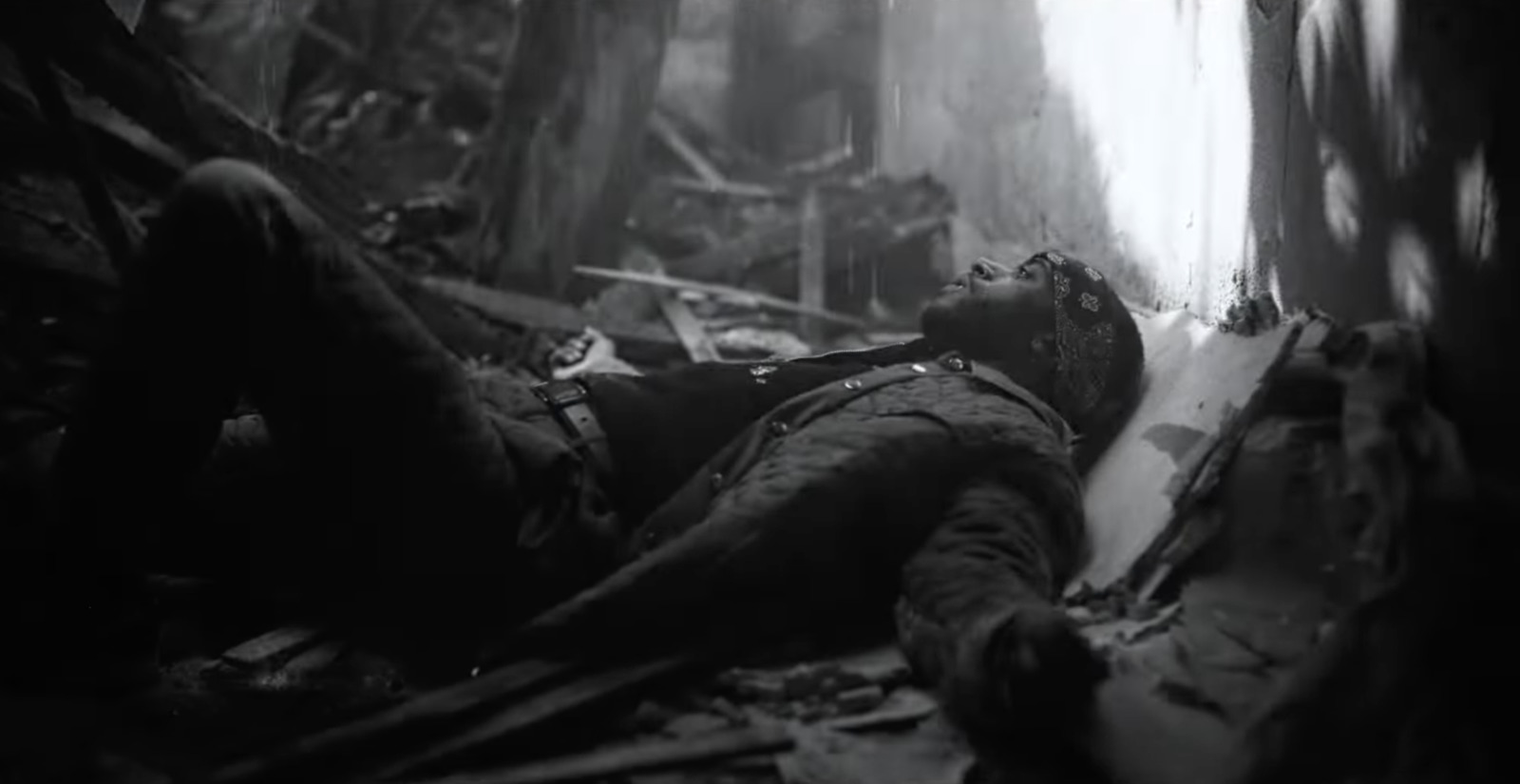 a man laying down in the middle of a forest