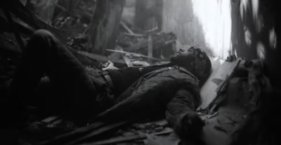 a man laying down in the middle of a forest