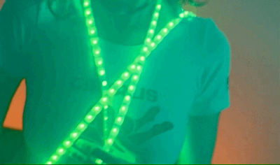 a woman wearing a green light up necklace