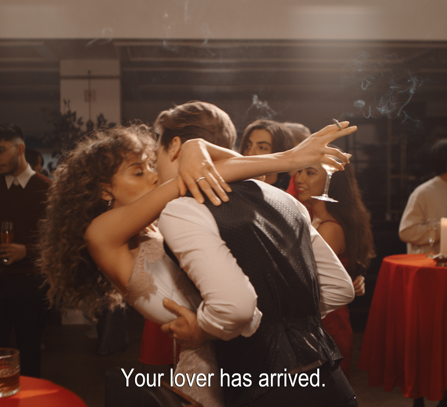 a man hugging a woman in front of a group of people