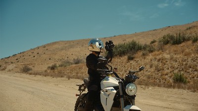 a person riding a motorcycle on a dirt road