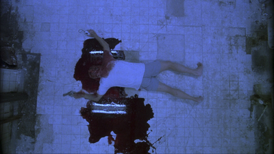 a man and a woman laying on a tiled floor