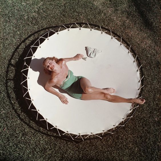 a man laying on top of a round table