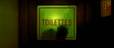 a sign that reads toilettes in a dark room