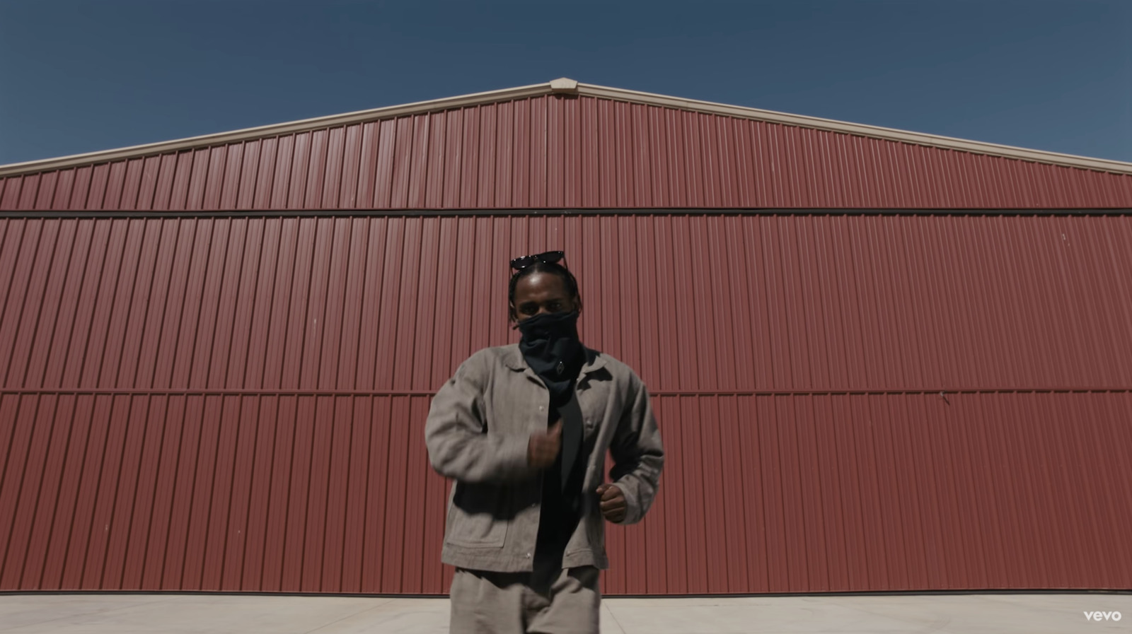 a man standing in front of a red building