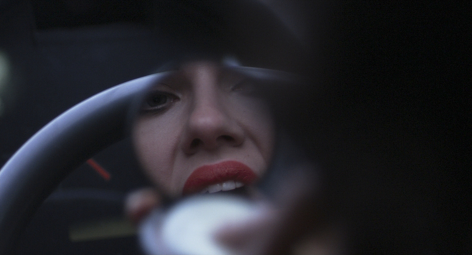 a woman driving a car while holding a steering wheel