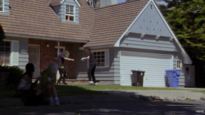 two people standing in front of a house